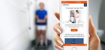 Hand holding a mobile device showing Medserena website with person blurred out in the background