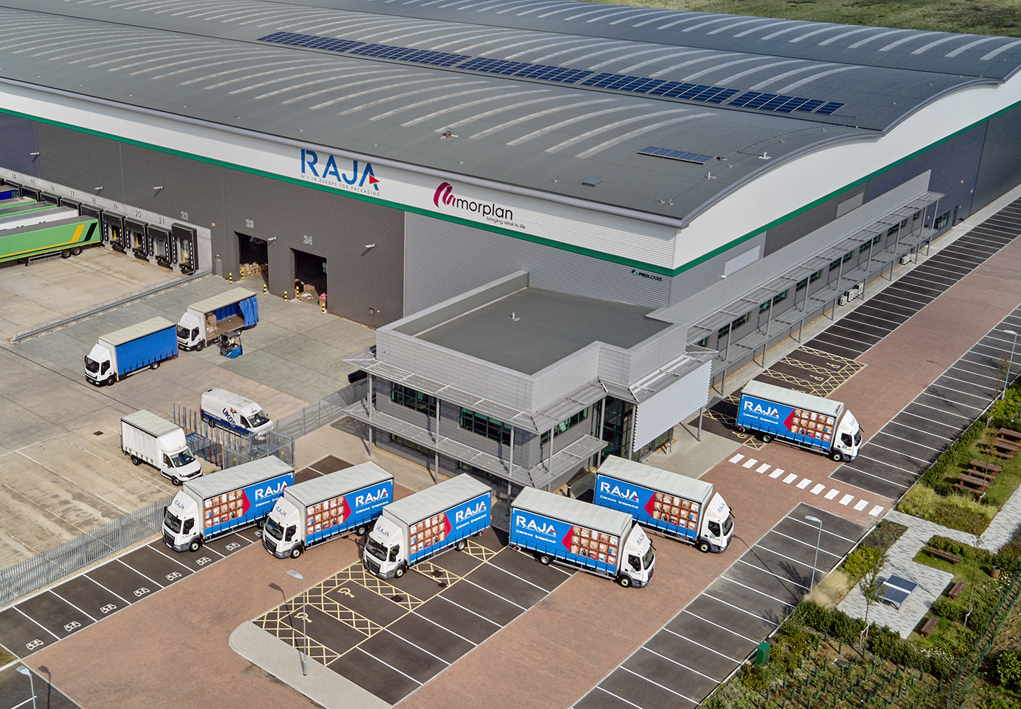 Aerial Shot of RAJA Trucks Outside Warehouse Building