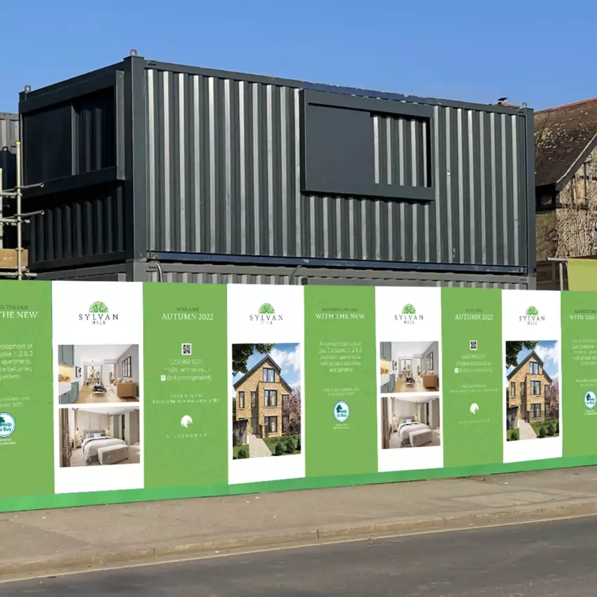 Mocked up image of some hoarding around a building site showing the developments logo and CGI images of the finished build