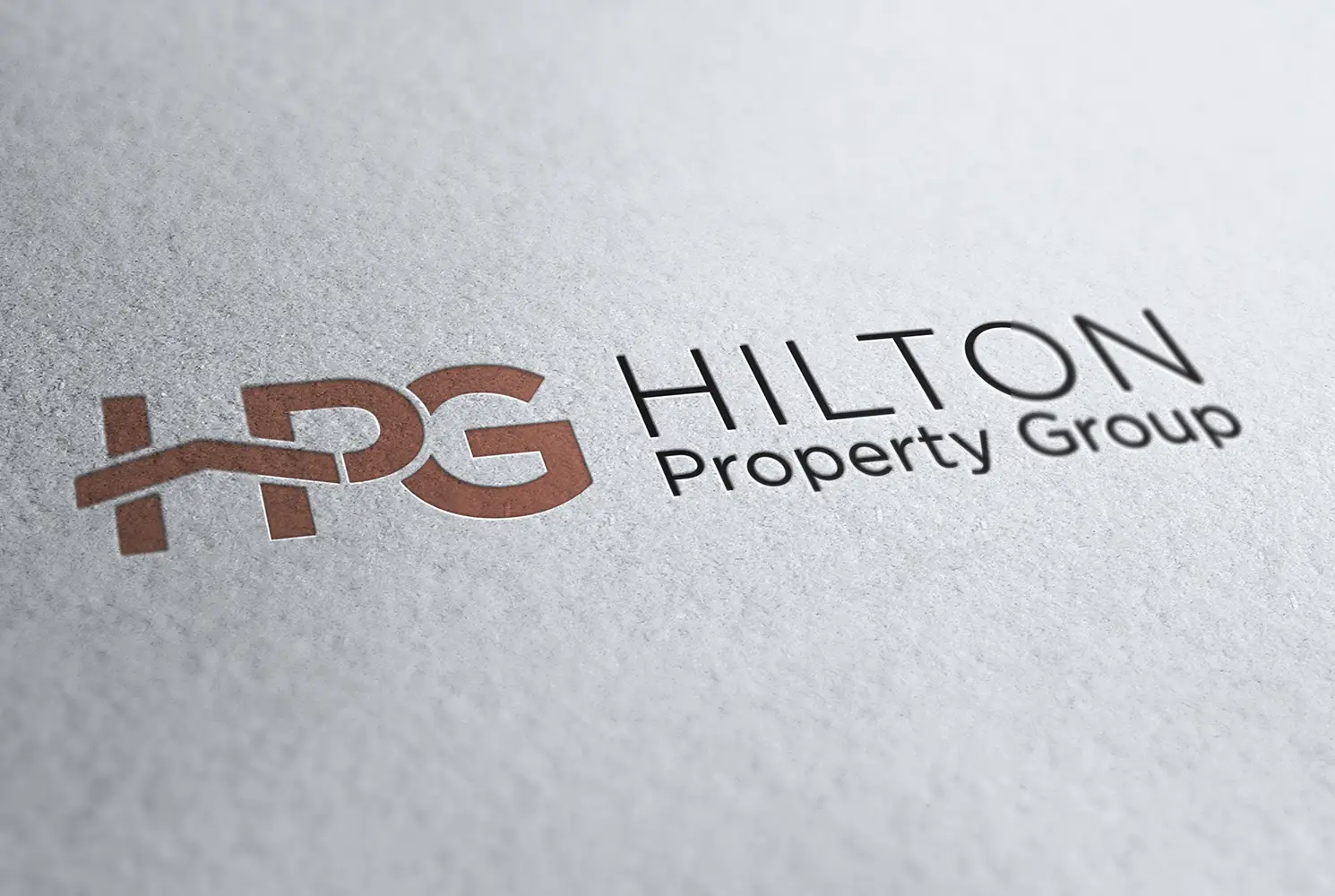 Mock up of the Hilton Property Group logo printed on uncoated paper