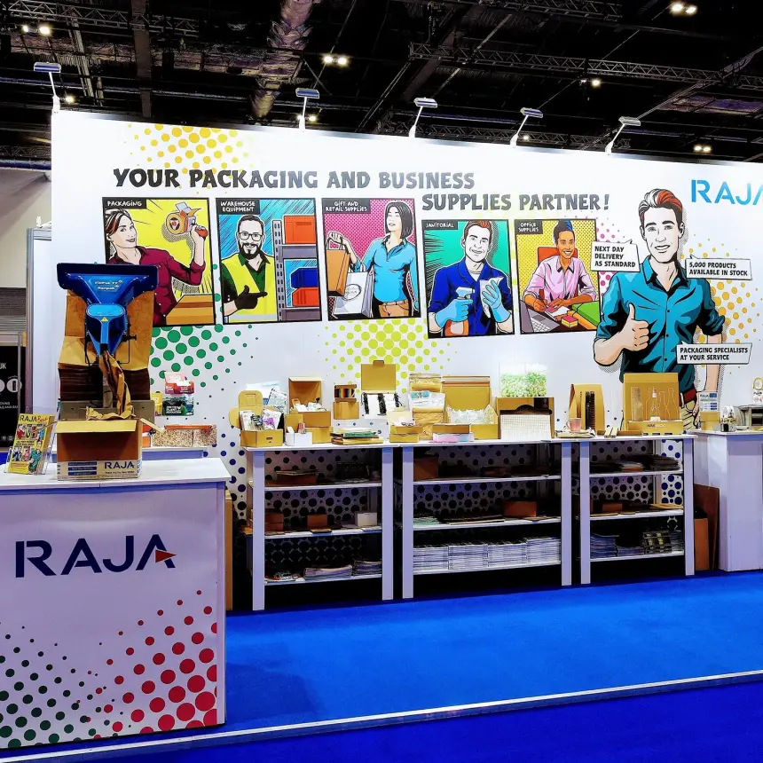 A photograph of an exhibition stand with bright cartoon style graphics and product samples displayed.